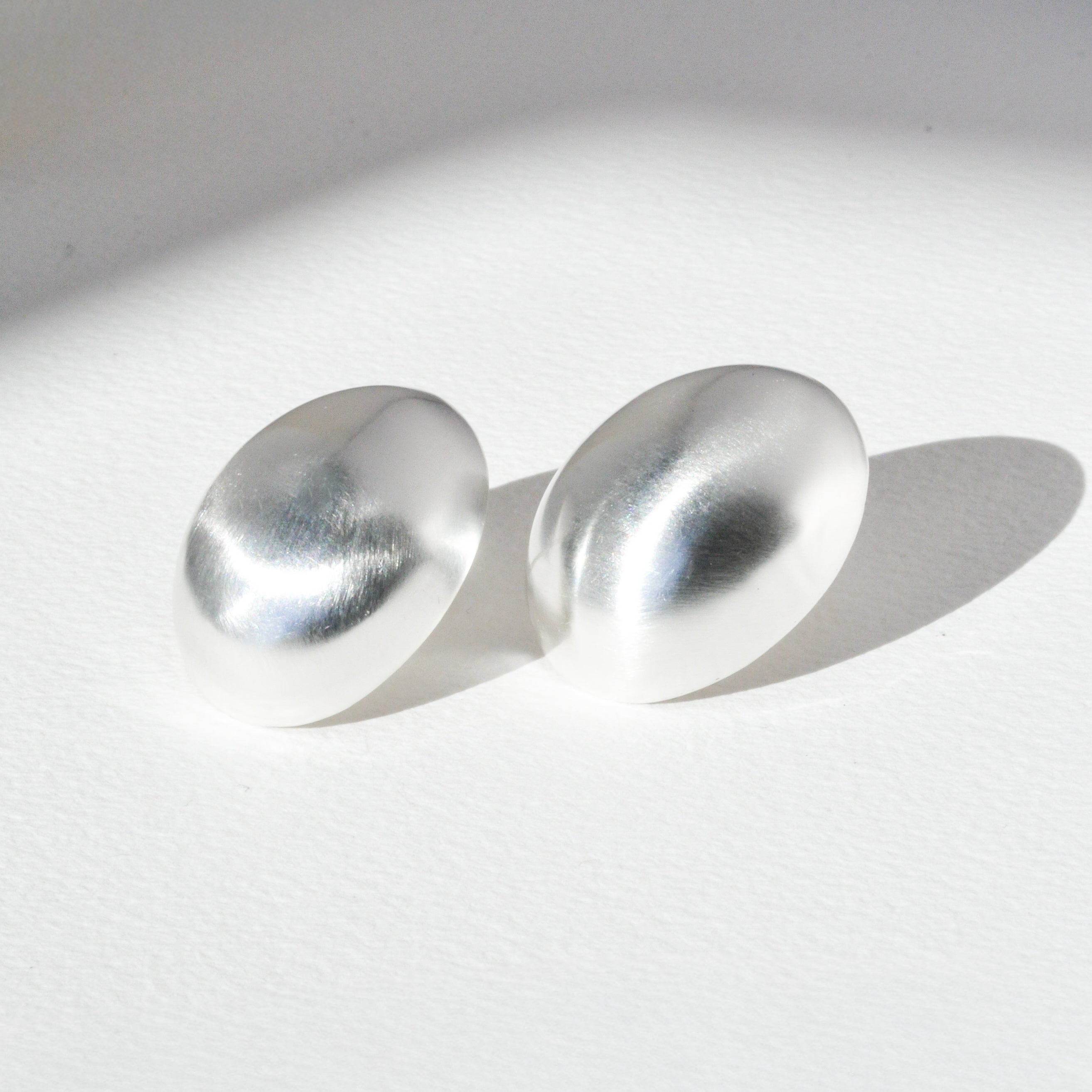 A pair of silver oval earrings