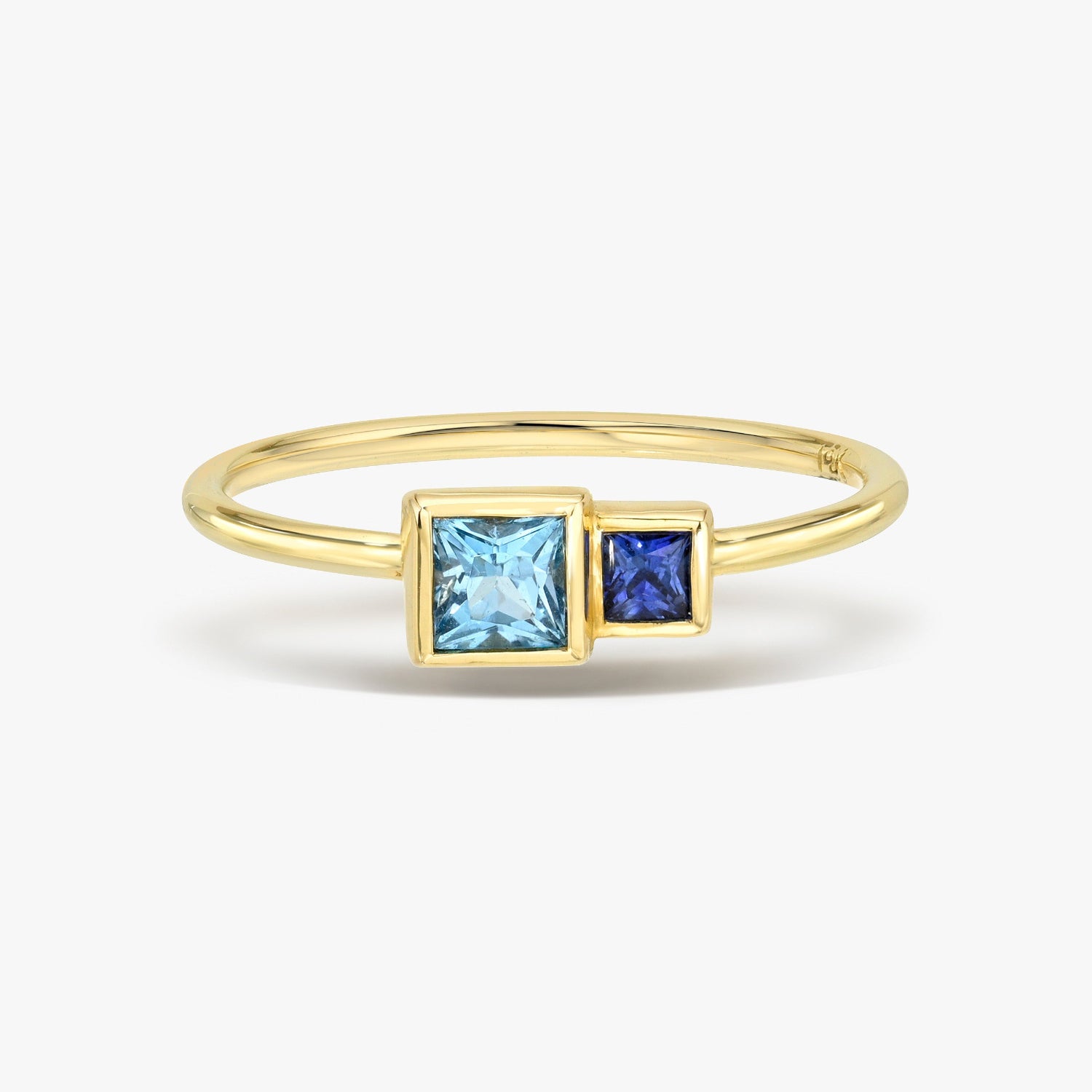 Gold ring with Blue Sapphire and Topaz gemstones on a white background