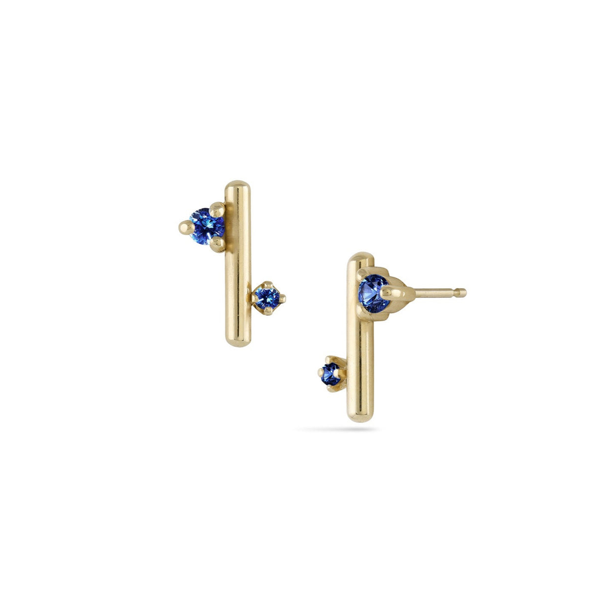 Gold earrings with blue gemstones on a white background