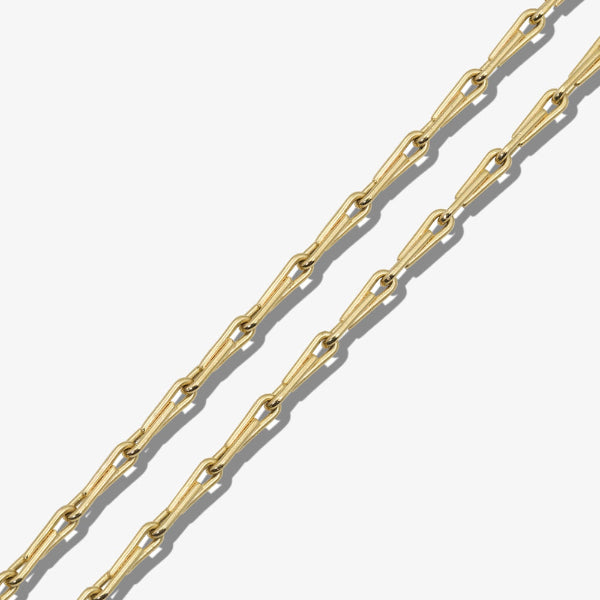 Gold chain on a light gray background