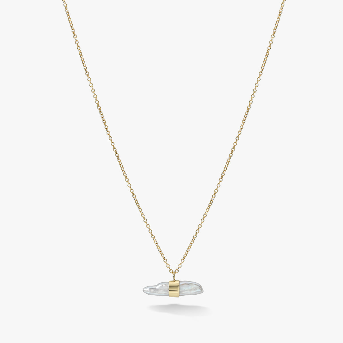 The Aalto Lagniappe Necklace from White Space Jewelry, in solid gold and natural pearl